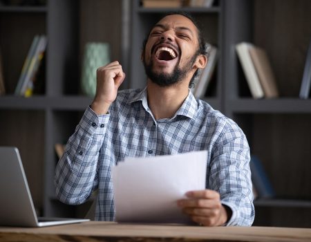 An excited college student celebrates after mastering the art of the abstract